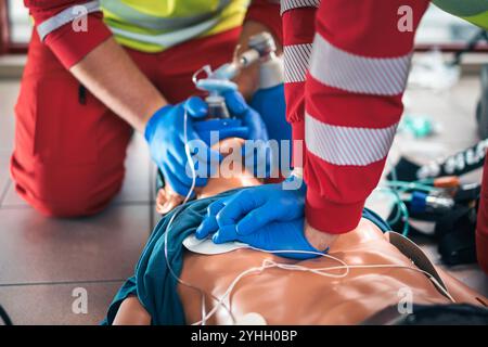 Mains du paramédical et du médecin en réanimation. Equipe du service médical d'urgence lors de la formation RCP sur mannequin. Thèmes sauvetage, urgence et santé Banque D'Images