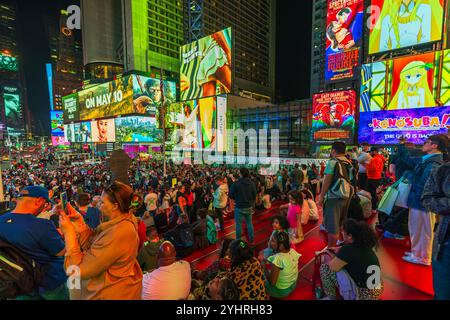 Une foule nombreuse s'est rassemblée à Times Square, New York, la nuit, contre des panneaux d'affichage et des publicités illuminées. New York. ÉTATS-UNIS. Banque D'Images