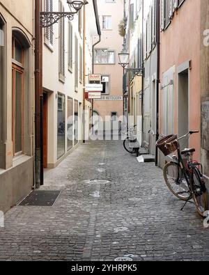 Ruelle pavée avec quelques vélos stationnés. Rue étroite dans la vieille ville. Banque D'Images