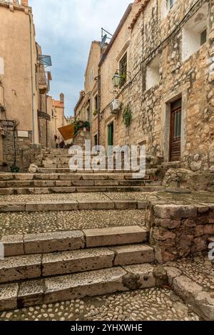 Dubrovnik – HR – Oct 18, 2024 Une rue étroite pavée de pierre à Dubrovnik, avec des bâtiments historiques en pierre, des marches rustiques et un charmant detai architectural Banque D'Images