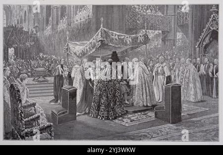 Couronnement du roi George V. L'archevêque de Cantorbéry oint le monarque des paumes des deux mains. Londres. 1911 le roi George vient de prêter le serment solennel sur la Bible ; à l'autel. Tête nue, il est venu s'asseoir à la chaire de Saint-Édouard. Quatre chevaliers de la Jarretière élèvent au-dessus de lui la verrière de tissu d'or. Le doyen de Westminster prit la miraculeuse ampoule Sainte de Thomas Becket et la cuillère dorée dans laquelle il versa un peu de l'huile sacrée avant de la remettre à l'évêque de Cantorbéry. Ce dernier oint alors le monarque en forme de croix sur la tête, la poitrine et les paumes de Banque D'Images