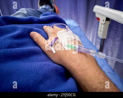 Vue rapprochée d'un bébé prématuré dans l'incubateur et tenu par une mère aimante Banque D'Images