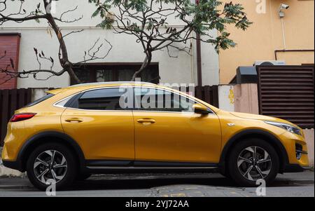 Bucarest, Roumanie – 1er septembre 2024 : gros plan de côté de la voiture jaune KIA Xceed garée dans la rue devant la maison Banque D'Images