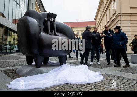 Rakovnik, République tchèque. 14 novembre 2024. Le peintre et sculpteur Jaroslav Rona (à droite) a dévoilé sa sculpture "le lecteur dans la chaise" devant le bâtiment du Centre d'études et de services sociaux polyvalents de Rakovnik, république tchèque, le 14 novembre 2024. Crédit : Ondrej Deml/CTK photo/Alamy Live News Banque D'Images