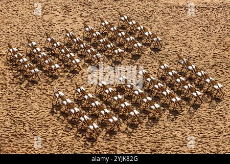 Une vue en angle élevé des chaises posées sur une plage de sable pour un mariage Banque D'Images
