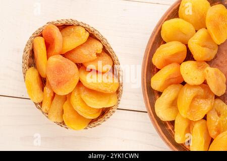 Abricots secs sucrés avec des plats faits maison sur une table en bois, gros plan, vue de dessus. Banque D'Images