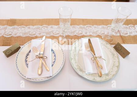 Configuration de table de mariage créative et unique avec des assiettes disparates et un décor rustique Banque D'Images