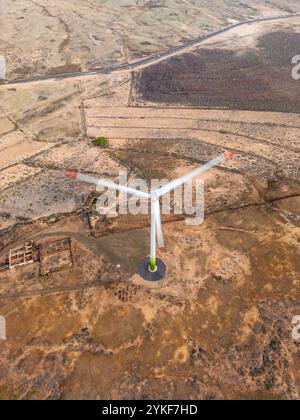 Vue aérienne d'une éolienne debout dans un paysage large et sec L'image met en évidence le contraste entre l'infrastructure moderne d'énergie renouvelable Banque D'Images
