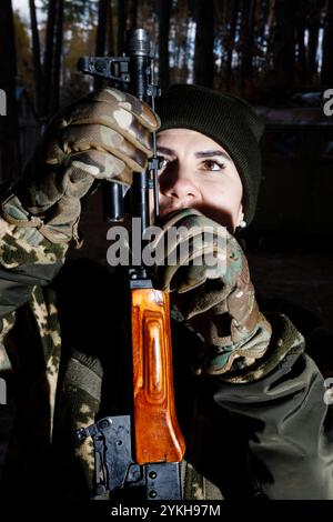 Une femme étudie les armes automatiques lors d'un entraînement militaire du groupe mobile féminin de défense aérienne 'sorcières de Bucha'. Les 'sorcières Bucha' protègent le ciel au-dessus de l'Ukraine. Les « sorcières Bucha » sont une unité mobile volontaire de défense aérienne en Ukraine, composée principalement de femmes. Opérant dans la région de Bucha, ils se spécialisent dans la tactique anti-drone et participent régulièrement à des exercices pour améliorer leurs compétences. Ils jouent un rôle vital dans la protection du ciel ukrainien. Au milieu de la guerre en cours, les femmes ukrainiennes assument des responsabilités cruciales, à la fois sur la ligne de front et dans le maintien de la func sociétale Banque D'Images