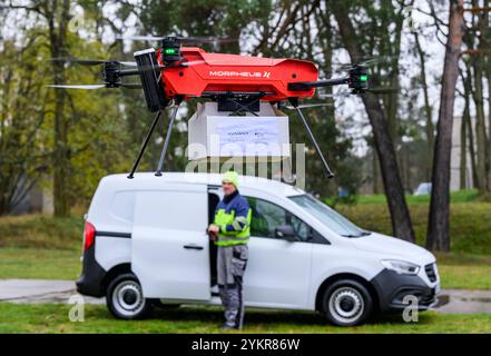 Welzow, Allemagne. 19 novembre 2024. Un drone Morpheus Logistik GmbH décolle avec un colis lors d’un événement de presse pour la livraison de journaux à l’aide de drones sur l’aérodrome de Welzow. Malgré une pluie battante, le projet pilote a commencé le même jour dans la région de Welzow, dans le sud du Brandebourg, pour livrer commercialement des journaux publicitaires à des clients privés en utilisant pour la première fois des drones volant automatiquement. Crédit : Patrick Pleul/dpa/Alamy Live News Banque D'Images