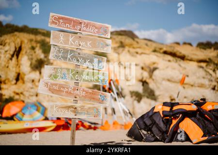 Signaux d'indication avec des objets colorés en arrière-plan de la plage de São Rafael, Albufeira Banque D'Images