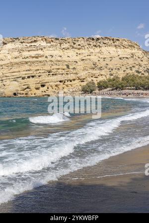 Une photo de la plage de Matala, avec les grottes de Matala sur le côté gauche Banque D'Images