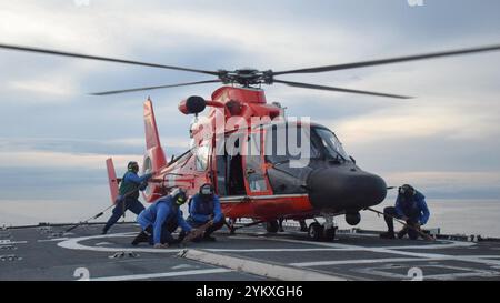 Un équipage d’arrimage Seneca de la Garde côtière Cutter (WMEC 906) sécurise un équipage d’hélicoptère MH-65 Dolphin embarqué de l’escadron tactique d’interception d’hélicoptères de la Garde côtière, 12 octobre 2024, peu de temps après avoir atterri sur le pont d’envol de la Cutter en mer dans l’est de l’océan Pacifique. L’équipage de Seneca a effectué une patrouille antidrogue de 61 jours dans la zone de responsabilité du onzième district de la Garde côtière à l’appui de la Force opérationnelle interinstitutions – Sud. (Photo de la Garde côtière américaine) Banque D'Images