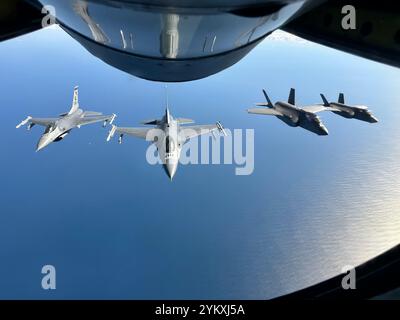 De gauche à droite, deux F-16C Fighting Falcons de l'US Air Force affectés à la 177th Fighter Wing, New Jersey Air National Guard, et deux F-35 Lightning II affectés à la 158th Fighter Wing, Vermont Air National Guard, suivent un avion-ravitailleur KC-135 Stratotanker affecté à la 171st Air Reaveling Wing, Pennsylvania Air National Guard, pour effectuer une mission de ravitaillement de routine sur le 9 octobre 2024, au large d'Atlantic City, New Jersey. L'avion a volé pendant 'Devilsmoke' 2024, une compétition de combat de chiens de trois jours organisée par le 119th Fighter Squadron 'Jersey Devils', qui comprend Banque D'Images