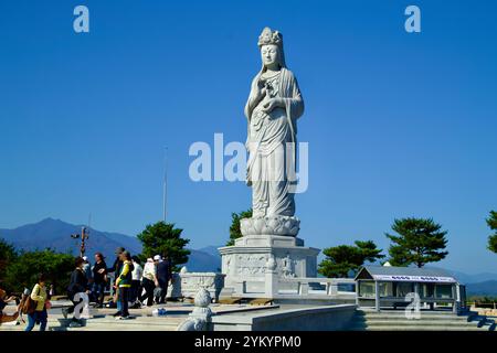 Comté de Yangyang, Corée du Sud - 3 novembre 2024 : une vue rapprochée de la statue emblématique d'Avalokitesvara d'eau de mer au temple Naksansa, avec des visiteurs explorateurs Banque D'Images