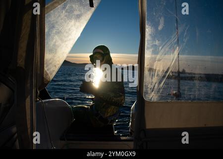 Plongeur en combinaison de plongée scaphandre sautant d'un bateau pour Snorkel - Norway Vacations Banque D'Images