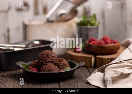 Boules de crème glacée au chocolat maison avec framboises et menthe Banque D'Images