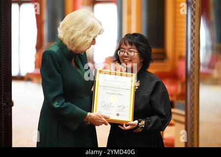 Queen Camilla avec Evangeline Khoo, lauréate senior, 15 ans, de Kuala Lumpur, Malaisie lors d'une réception pour les gagnants du concours de rédaction Queen's Commonwealth, au Buckingham Palace à Londres. Date de la photo : jeudi 21 novembre 2024. Banque D'Images