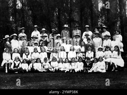 Une photographie de groupe de femmes, de garçons et de filles. Une inscription au crayon dit 'J. Mepham and sons, juillet 1918'. La seule référence que je puisse trouver à cette entreprise à ce moment-ci, se rapporte à la blanchisserie à vapeur Rushden d'Allen Road et à d'autres adresses dans les environs de Rushden, Northampton, Angleterre. Le propriétaire était John Mepham. Banque D'Images