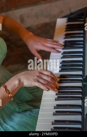 Gros plan de mains féminines jouant gracieusement du piano Banque D'Images