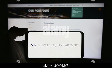 Stuttgart, Allemagne, 03-25-2024, personne tenant un téléphone portable avec le logo de la société britannique NB Private Equity Partners Ltd. (NBPE) devant la page Web. Focu Banque D'Images