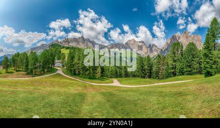 Les sommets du groupe Rosengarten se dressent derrière une forêt luxuriante dans les Dolomites italiennes, Trentin Haut-Adige, Italie Banque D'Images