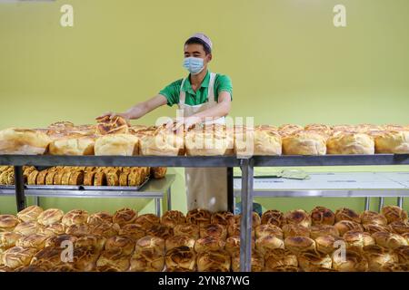 Le personnel a placé des petits pains à la vapeur Kunguo fraîchement cuits.Xining, China.20th novembre 2024. Le processus de production de Kunguo Momo implique que le personnel verse de l’huile de colza dans la pâte fermentée, ajoute des épices naturelles telles que la levure rouge, le curcuma et la farine de soja, puis les répartit uniformément à la main pour former la pâte. Le nom « Kunguo » vient des moules métalliques uniques utilisés dans son processus de production. Il est rapporté que par le biais de plateformes de streaming en direct en ligne, en plus d'être vendu à diverses régions de Chine, Kunguo Momo de Haiya Kunguo Momo Industry base a été exporté vers des pays tels Banque D'Images