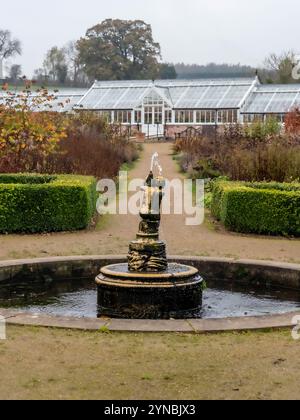 Fontaine à Helmsley Walled Garden vue sur la toile de fond de la serre victorienne. Yorkshire du Nord. ROYAUME-UNI. Banque D'Images