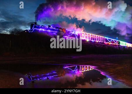Paignton, Royaume-Uni. 27 novembre 2024. Le voyage inaugural du train de lumières de Noël 2024 quitte Paignton en route pour kingswear. Le train est géré par le Dartmouth Steam Railway dans le Devon. C'est le premier train de lumières à vapeur du Royaume-Uni !le train de lumières de Noël est désormais un événement incontournable dans le calendrier des fêtes du Sud-Ouest et capte l'imagination des enfants et des adultes ! Crédit : Mark Passmore / Alamy Live News Banque D'Images