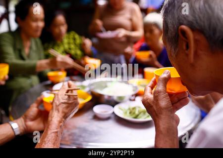 Un groupe d'amis déguste un repas dans un restaurant végétarien, an Giang Province, Delta du Mékong, Vietnam, Indochine, Asie du Sud-est, Asie, Asie Banque D'Images