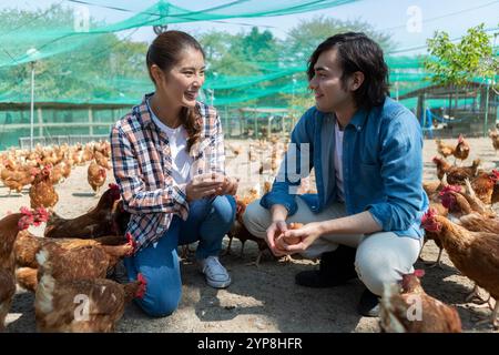 Hommes et femmes dans une ferme avicole Banque D'Images