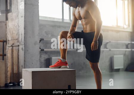 Un athlétique dévoué engagé dans un entraînement intense au gymnase avec une routine d'exercices Box Banque D'Images