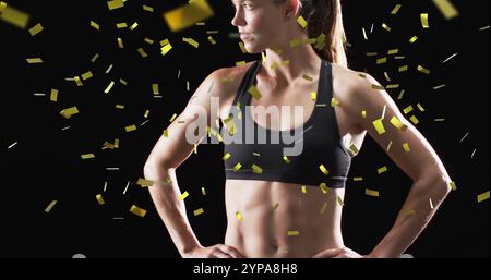 Image de confettis tombant sur une athlète féminine caucasienne sur fond noir Banque D'Images