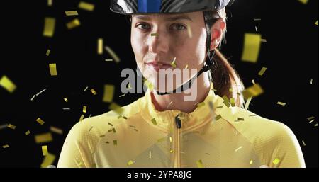 Image de confettis tombant sur une cycliste féminine caucasienne sur fond noir Banque D'Images