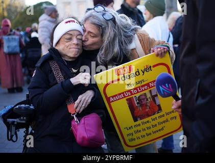 L'actrice Liz Carr (à gauche) participe à une manifestation à Old Palace Yard à Westminster, Londres, pour s'opposer au projet de loi sur les adultes en phase terminale (fin de vie). Un projet de loi visant à légaliser l'aide à mourir en Angleterre et au pays de Galles a levé son premier obstacle parlementaire après que les députés ont voté 330 contre 275, majorité 55, pour l'approuver en deuxième lecture. Date de la photo : vendredi 29 novembre 2024. Banque D'Images