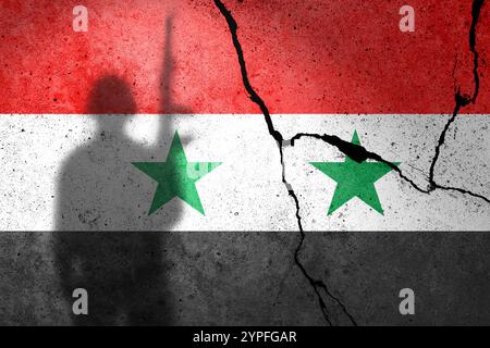 Drapeaux de Syrie peints sur un mur de béton cranqué avec ombre de soldat Banque D'Images