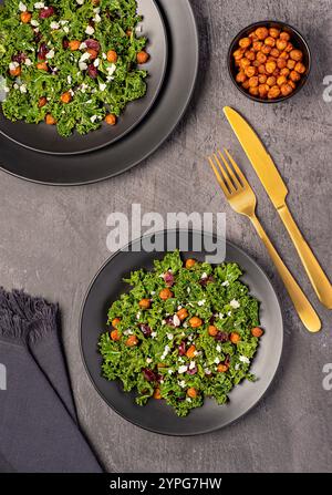 Photographie culinaire de salade avec pois chiches croustillants rôtis, chou frisé, canneberges séchées et fromage de chèvre, repas végétarien, protéines végétales, fibres alimentaires Banque D'Images