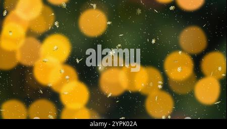 Image de taches de lumière sur fond de neige tombant Banque D'Images