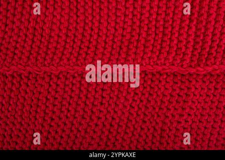 Fond tricoté en laine. Tricot rouge texturé Noël tissu Banque D'Images