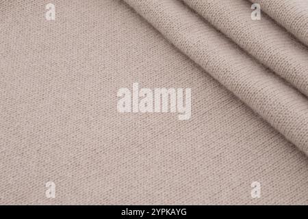 Fond de texture de tissu tricoté en laine beige plié Banque D'Images