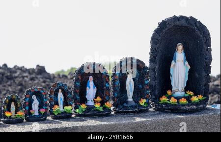 Petites statues de la Vierge à l'intérieur d'une petite grotte de lave volcanique en vente sur l'Etna près de Catane, Sicile, Italie Banque D'Images