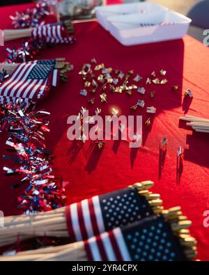 Drapeaux américains et épingles sur une nappe rouge lors d'une célébration communautaire, montrant la configuration patriotique de la table et la lumière du soleil, Californie, États-Unis, juillet 2024 Banque D'Images