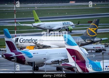 Flughafen Düsseldorf, Eurowings, Condor Flieger auf dem Vorfeld, Air Baltic Flugzeug auf dem taxiway zum Start, Düsseldorf, NRW, Deutschland, Flughafen dus *** Aéroport de Düsseldorf, Eurowings, Condor Aircraft sur l'aire de trafic, Air Baltic sur la voie de circulation pour le décollage, Düsseldorf, NRW, Allemagne, Aéroport dus Banque D'Images