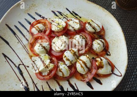 Cuisine italienne, Insalata Caprese, tomates de vigne, mozza de buffle disposés sur une assiette, vinaigre balsamique, huile d'olive, salade, restaurant italien, restauran Banque D'Images