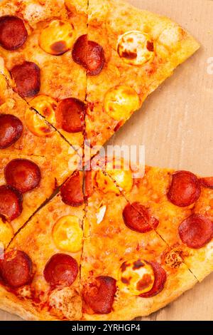 Gros plan d'une pizza pepperoni fraîchement cuite sur une surface en carton la croûte dorée et le fromage fondu créent un look invitant et appétissant, parfait Banque D'Images