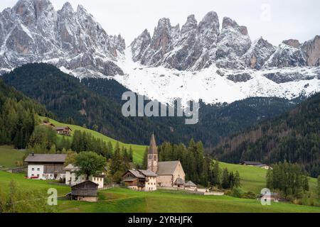Vue panoramique sur le village de Santa Magdalena, niché dans les vallées verdoyantes des Dolomites, Italie maisons alpines traditionnelles et superbes enneigées m Banque D'Images