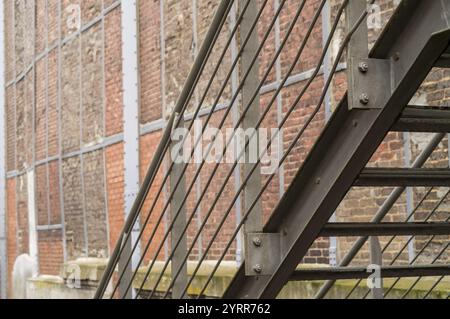 Gros plan de l'escalier d'évacuation d'incendie en métal sur le vieux bâtiment de mur de briques Banque D'Images