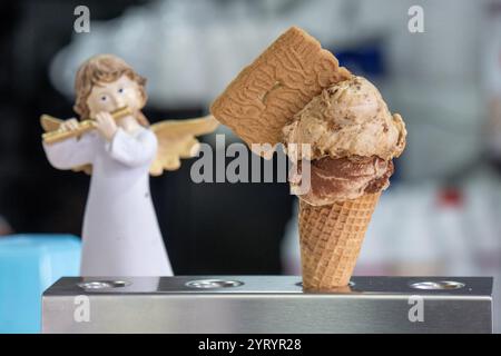 Trèves, Allemagne. 04th Dec, 2024. Une crème glacée spéculoos sur une boule de tiramisu est prête à être vendue et consommée dans un glacier à Trèves. Certains glaciers de Rhénanie-Palatinat sont également ouverts en hiver. L'offre va de la crème glacée aux gaufres, crêpes, gâteaux et boissons chaudes. Crédit : Harald Tittel/dpa/Alamy Live News Banque D'Images