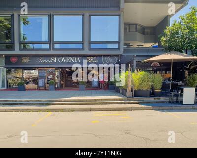 Lake Bled, Slovénie - 28 juin 2024 : le meilleur magasin d'alimentation local est l'épicerie, façade ouverte avec des panneaux et des gens Banque D'Images