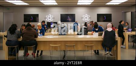 Huntington, New York, États-Unis - 1er mai 2022 : les clients interagissent avec le personnel de vente au détail dans un magasin Apple tout en explorant les produits électroniques dans une technologie spacieuse Banque D'Images